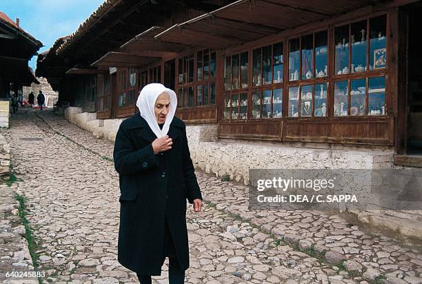 Woman in front of the old bazaar in Kruje, Albania.