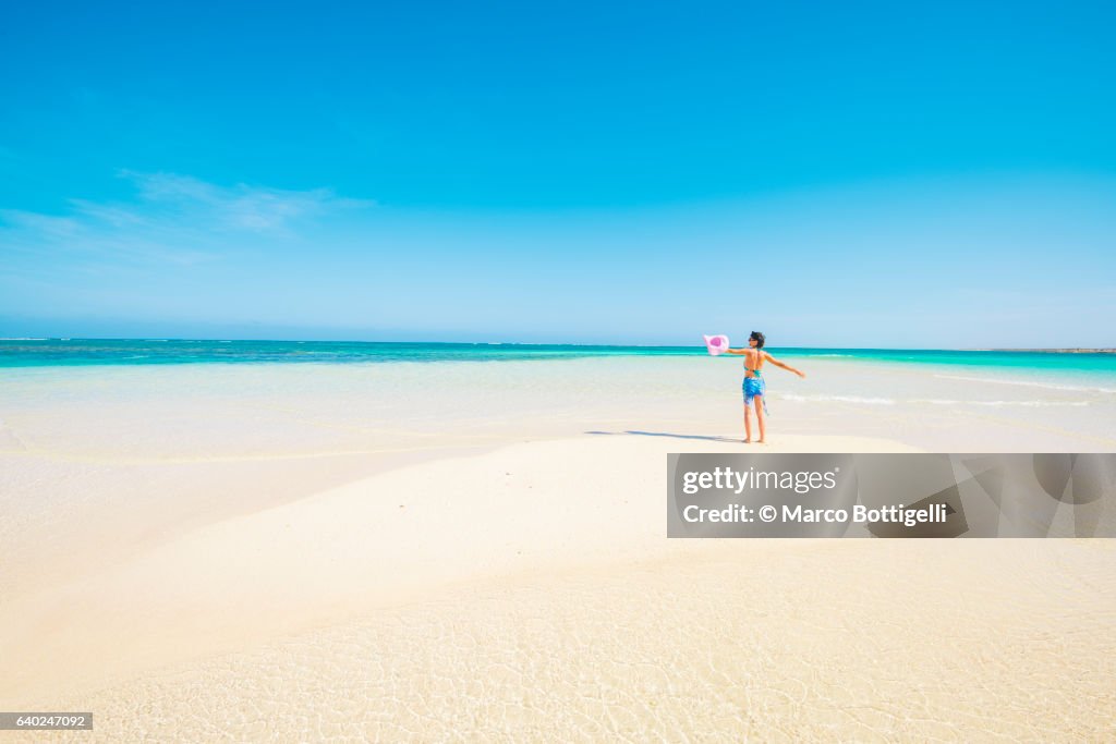 Woman with sarong in pristine waters at Turquoise Bay, Ningaloo Coast, Exmouth, Western Australia.