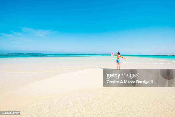 woman with sarong in pristine waters at turquoise bay, ningaloo coast, exmouth, western australia. - western australia coast stock pictures, royalty-free photos & images