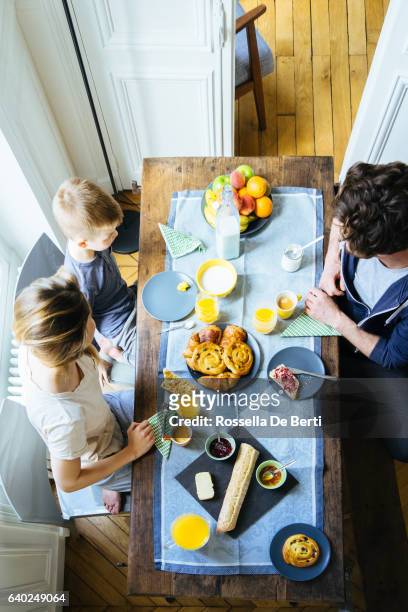 happy family having breakfast together overhead view - spread over stock pictures, royalty-free photos & images