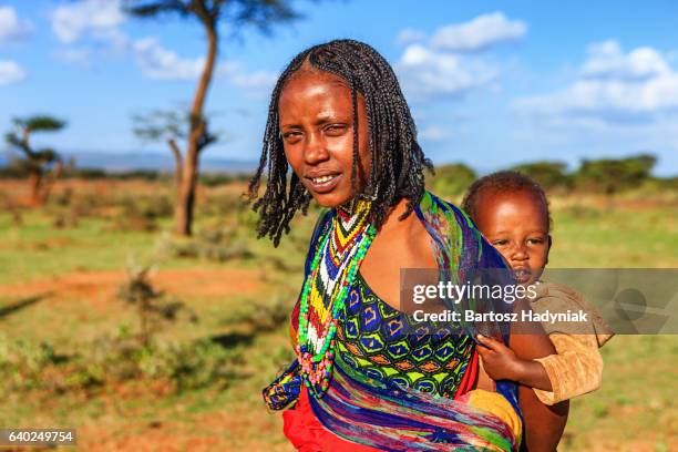 woman from borana tribe carrying her baby, ethiopia, africa - borana stock pictures, royalty-free photos & images