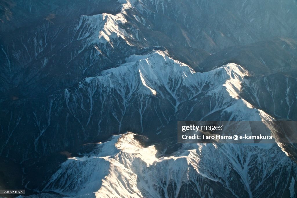 Snowcapped Southern Alps mountain ridge aerial view from airplane