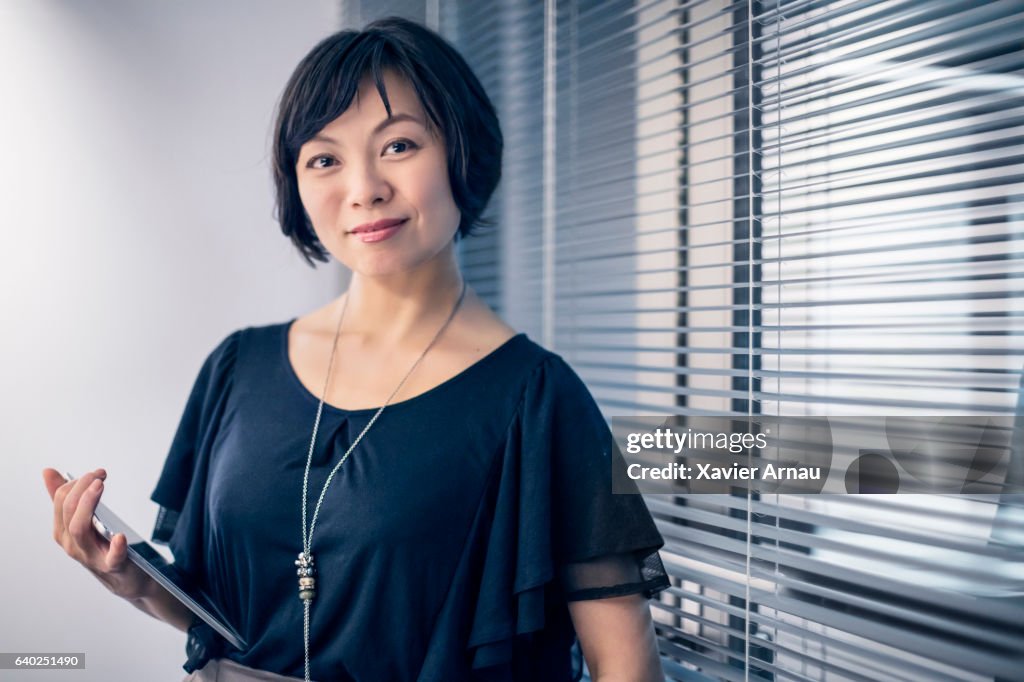 Portrait of businesswoman holding digital tablet