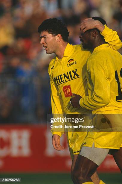 French soccer player Zinedine Zidane during a match between Cannes and Olympique de Marseille .