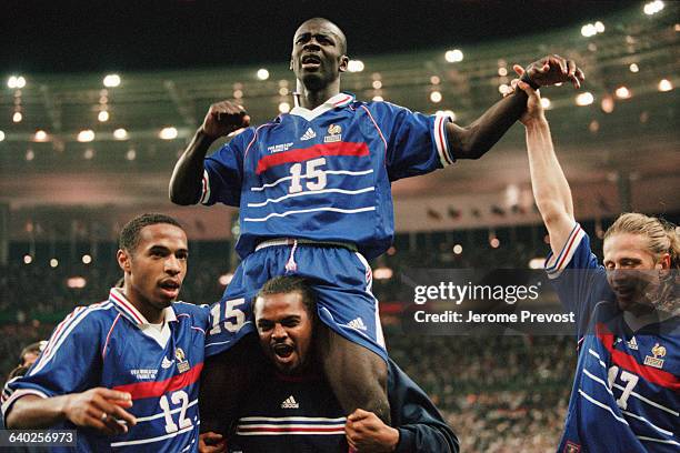 French striker Lilian Thuram celebrates with Thierry Henry, Bernard Lama and Emmanuel Petit after France's victory over Croatia in the 1998 FIFA...