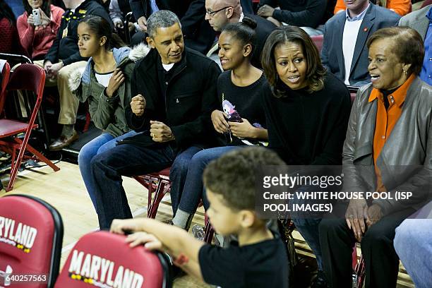 From L to R, daughter Malia Obama, President Barack Obama, Sasha Obama, First Lady Michelle Obama and Marian Robinson attend a men's NCCA basketball...