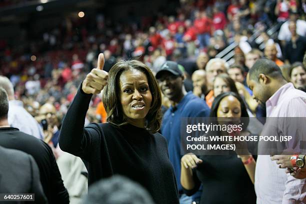 First Lady Michelle Obama gives the thumbs up during a men's NCCA basketball between University of Maryland and Oregon State University, November 17,...