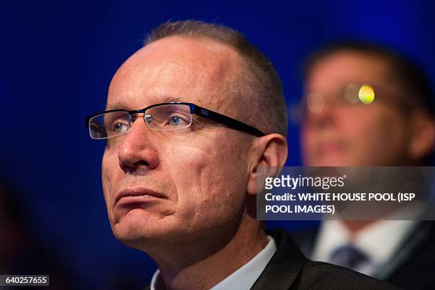 Robert Thomson, CEO of News Corp, listens to President Barack Obama make remarks at the Wall Street Journal CEO Council annual meeting, at the Four...