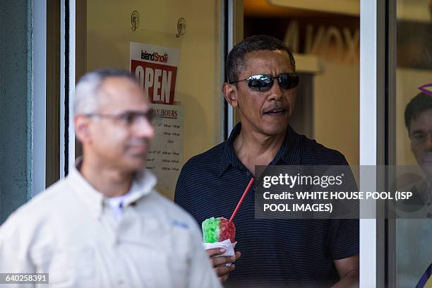 President Barack Obama exits Island Snow at Kailua Beach Center where he, daughters Sasha, Malia and friends and family went for Shave Ice on...