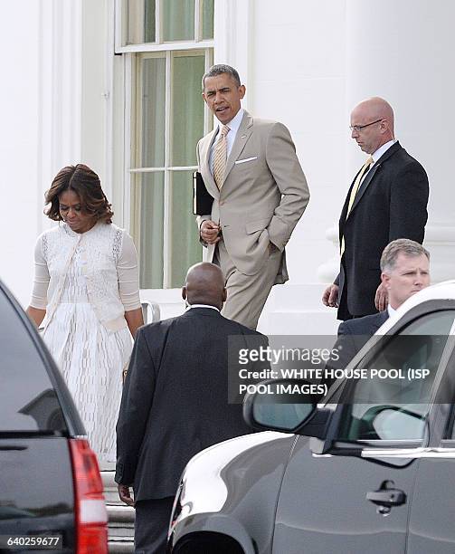 President Barack Obama leaves the White House with his wife Michelle Obama to attend a church service April 20 2014 in Washington, DC.