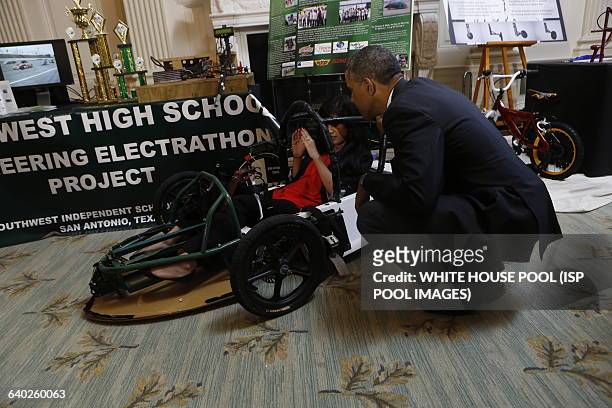 President Barack Obama speaks with Deidre Carrillo, winner of the Electrathon and NCWIT Aspiration in Computing for her electric car project during...
