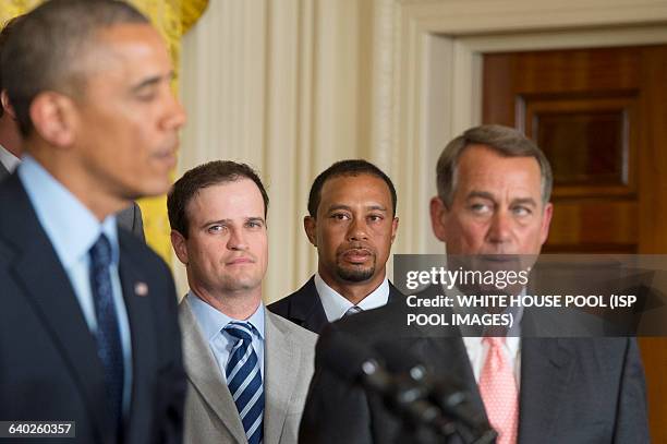 Golfer Tiger Woods listens to remarks from US President Barack Obama , beside US golfer Zack Johnson and US Speaker of the House Republican John...