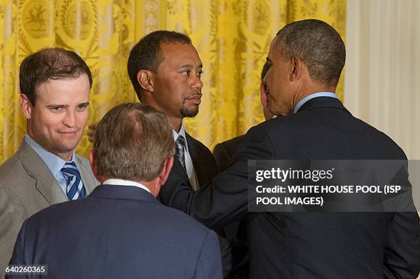 President Barack Obama greets US golfer Tiger Woods , beside US golfer Zack Johnson and PGA Tour Commissioner Tim Finchem at an event hosting the...