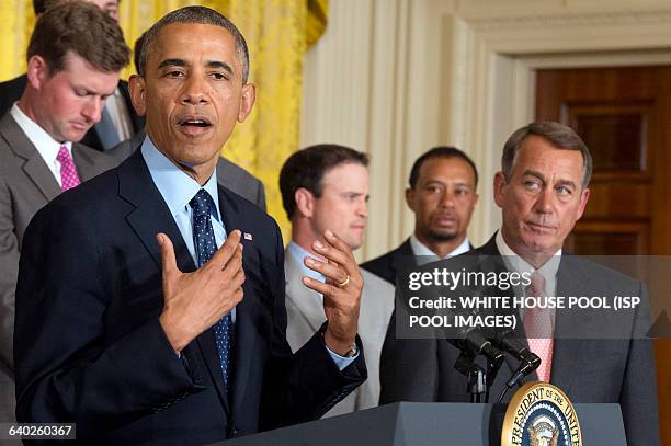 President Barack Obama , delivers remarks in front of US Speaker of the House Republican John Boehner , US golfer Tiger Woods and US golfer Zack...