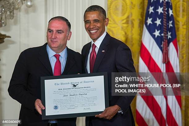 President Barack Obama poses for a photo with celebrity chef Jose Andres after awarding him the Outstanding American by Choice recognition by the...