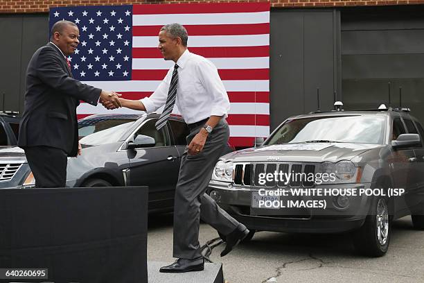 President Barack Obama is welcomed to the stage by Transportation Secretary Anthony Foxx at the The Federal Highway Administration's Turner-Fairbank...