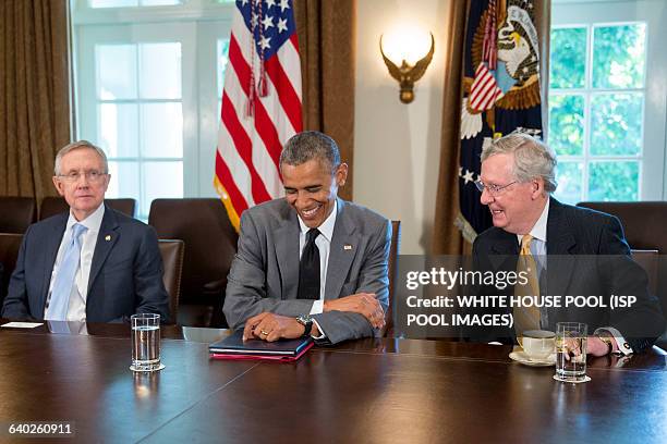 President Barack Obama, center, laughs as he talks to Senate Minority Leader Mitch McConnell, a Republican from Kentucky, right during a meeting with...