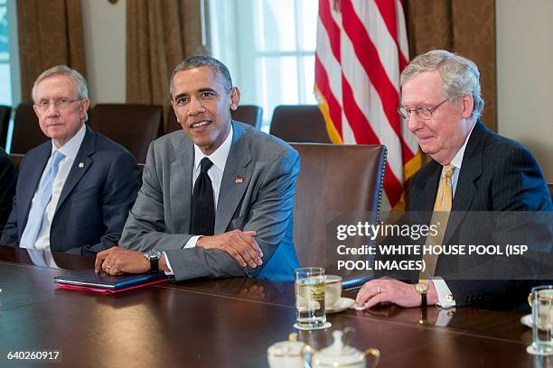 President Barack Obama, center, holds a meeting with members of Congress on foreign policy including Senate Majority Leader Harry Reid, a Democrat...