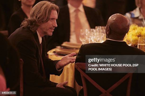 American human rights activist John Prendergast talks with Uganda President Yoweri Museveni during a dinner on the occassion of the U.S.-Africa...