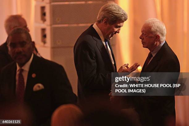 Secretary of State John Kerry talks with former President Jimmy Carter during a dinner on the occassion of the U.S.-Africa Leaders Summit on the...