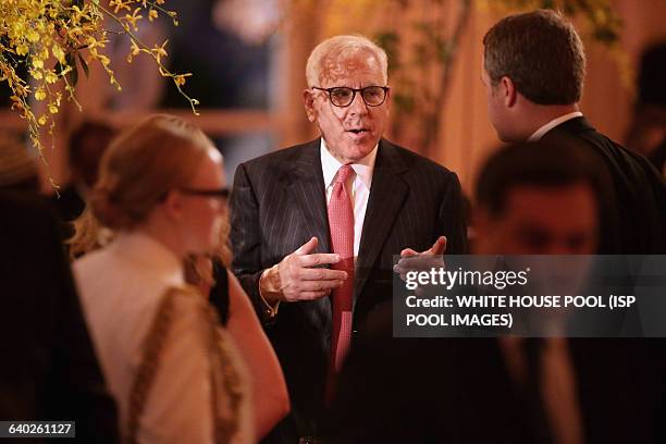 Managing Director of the Carlyle Group David Rubenstein talks with guests during a dinner on the occassion of the U.S.-Africa Leaders Summit on the...