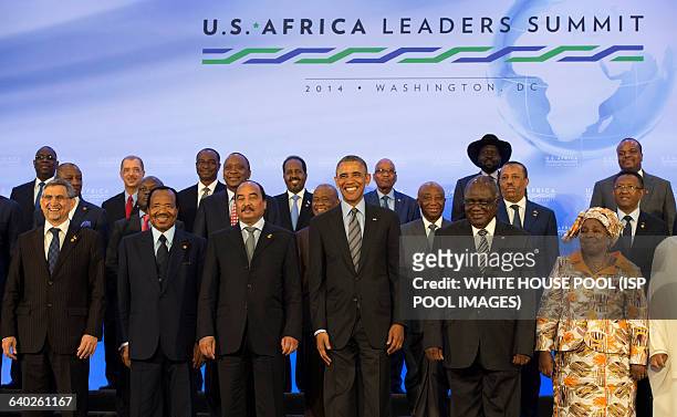 President Barack Obama takes part in the family photo at the Africa Leaders Summit, standing in between Mohamed Ould Abdel Aziz, President of the...