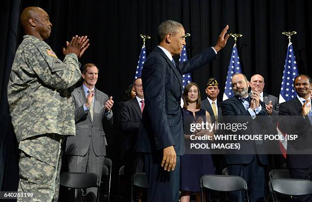 President Barack Obama acknowledges applause after signing HR 3230, The Veteran's Access to Care through Choice, Accountability and Transparency Act...