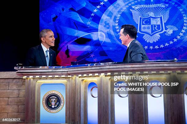 President Barack Obama, left, talks to television personality Stephen Colbert during a taping of Comedy Central's "The Colbert Report" in Lisner...