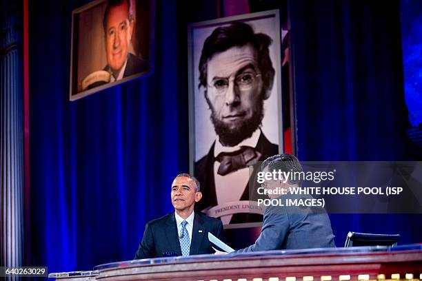 President Barack Obama, left, tapes Comedy Central's "The Colbert Report" with television personality Stephen Colbert in Lisner Auditorium at George...