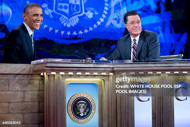 President Barack Obama, left, tapes Comedy Central's "The Colbert Report" with television personality Stephen Colbert in Lisner Auditorium at George...