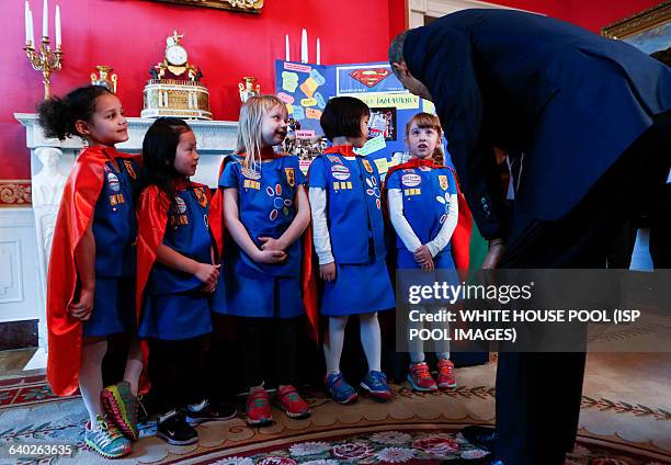 Us President Barack Obama poses with a group of 6 years old Girls Scouts from Tulsa Oklahoma who designed a battery powered page turner to help...