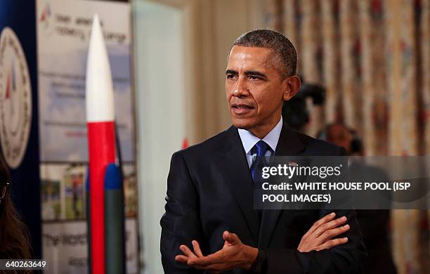 Us President Barack Obama listens to a team from the US Virgin Islands that design rockets for the Team America Rocketry Challenge, during the 2015...