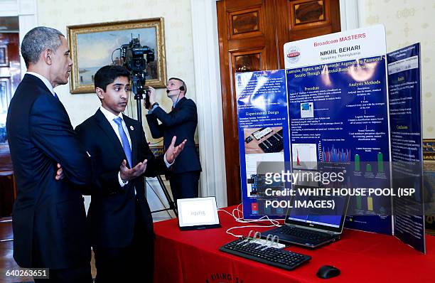 Us President Barack Obama listens to Nikhil Behari from Sewickley, Pennsylvania, who created a security system that uses additional data to verify...