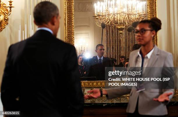 Us President Barack Obama listens to Sophia Sanchez-Maes from Las Cruces, New Mexico, who identified a form of Yellowstone algae that could turn...