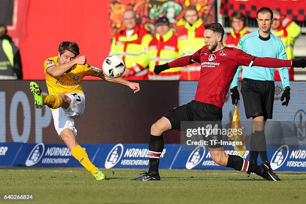 Andreas Lambertz of Dynamo Dresden and Tim Matavz of FC Nuernberg battle for the ball during the Second Bundesliga match between 1. FC Nuernberg and...