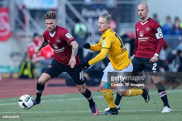 Tobias Kempe of FC Nuernberg and Marvin Stefaniak of Dynamo Dresden battle for the ball during the Second Bundesliga match between 1. FC Nuernberg...
