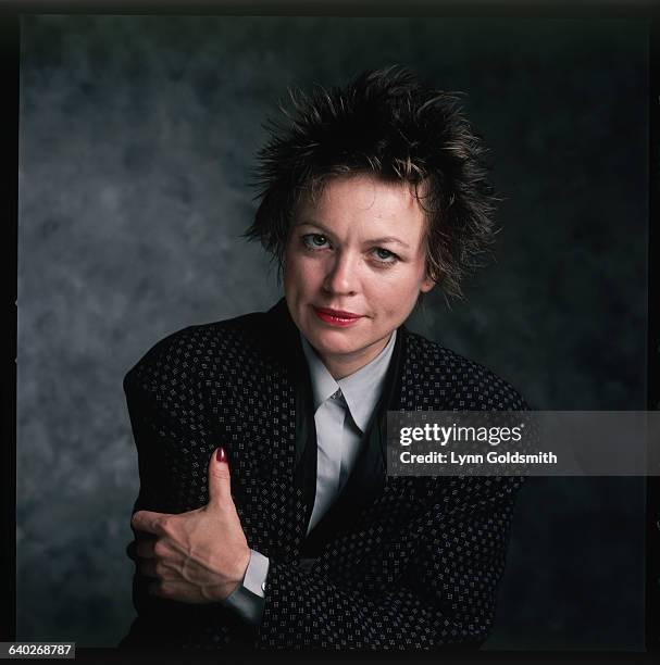 Performance artist Laurie Anderson is seen with her arms folded in this studio portrait. Undated.