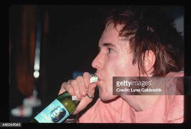 Close-up of Sex Pistols singer Johnny Rotten drinking a beer during the Sex Pistols' 1978 Tour through the US South, January 1978.