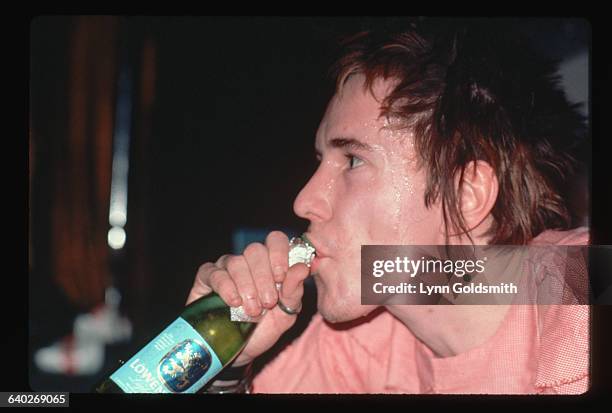 Close-up of Sex Pistols singer Johnny Rotten drinking a beer during the Sex Pistols' 1978 Tour through the US South, January 1978.