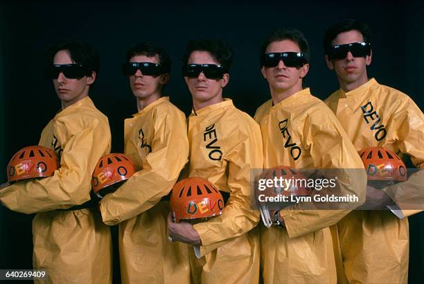 New wave band Devo wears their trademark yellow plastic jump suits.