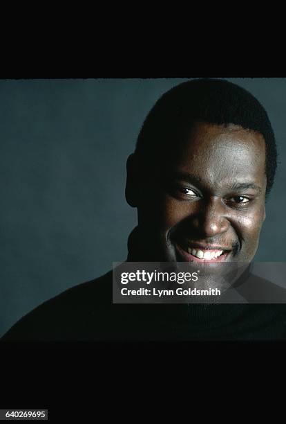 Studio portrait of Luther Vandross. He is shown close-up, wearing a black turtleneck. Photograph, 1982.