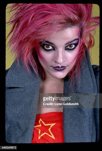 Portrait of singer/actress Nina Hagen, with pink dyed hair and heavy make-up. Photograph, 1980.