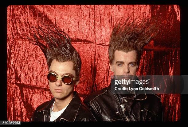 The dance-op group The Pet Shop Boys are shown in a studio portrait, with hair that is dyed red and highly moussed, so that it holds in curves on the...