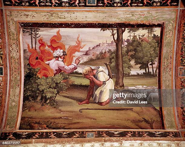 Painting by Raphael showing Moses receiving wisdom from God who is shown speaking from within a burning bush. | Located in: Vatican City, circa 1500.