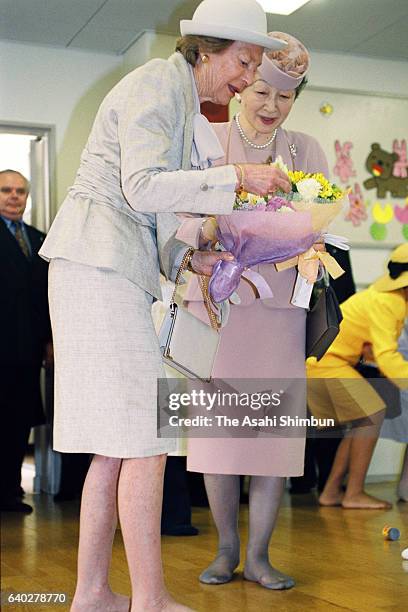 Grand Duchess Josephine Charlotte of Luxembourg and Empress Michiko visit the Home for Infants of the Japan Red Cross Medical Center on April 7, 1999...