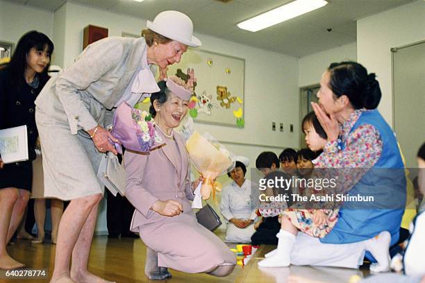 Grand Duchess Josephine Charlotte of Luxembourg and Empress Michiko visit the Home for Infants of the Japan Red Cross Medical Center on April 7, 1999...
