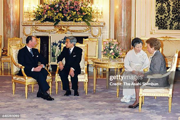 Grand Duke Jean of Luxembourg and Emperor Akihito talk while Empress Michiko and Grand Duchess Josephine Charlotte of Luxembourg talk during their...