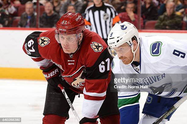 Lawson Crouse of the Arizona Coyotes and Jack Skille of the Vancouver Canucks get ready during a faceoff at Gila River Arena on January 26, 2017 in...