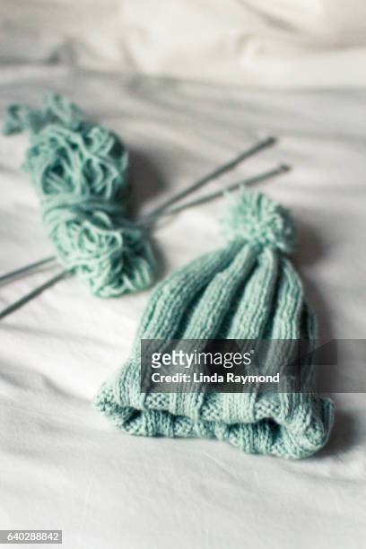 a hand made  knitted toque with a ball of wool and knitting needle - ball of wool ストックフォトと画像