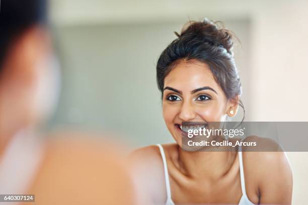 good skincare definitely pays off - woman in mirror stock pictures, royalty-free photos & images